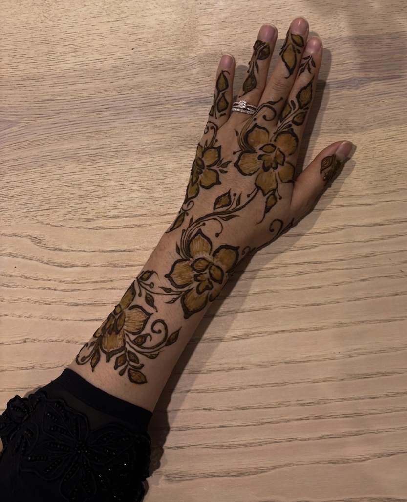 Bold floral henna hand and arm design